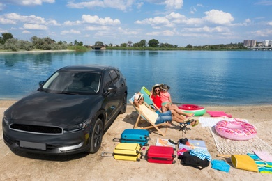 Image of Family with beach accessories and car near river. Summer trip