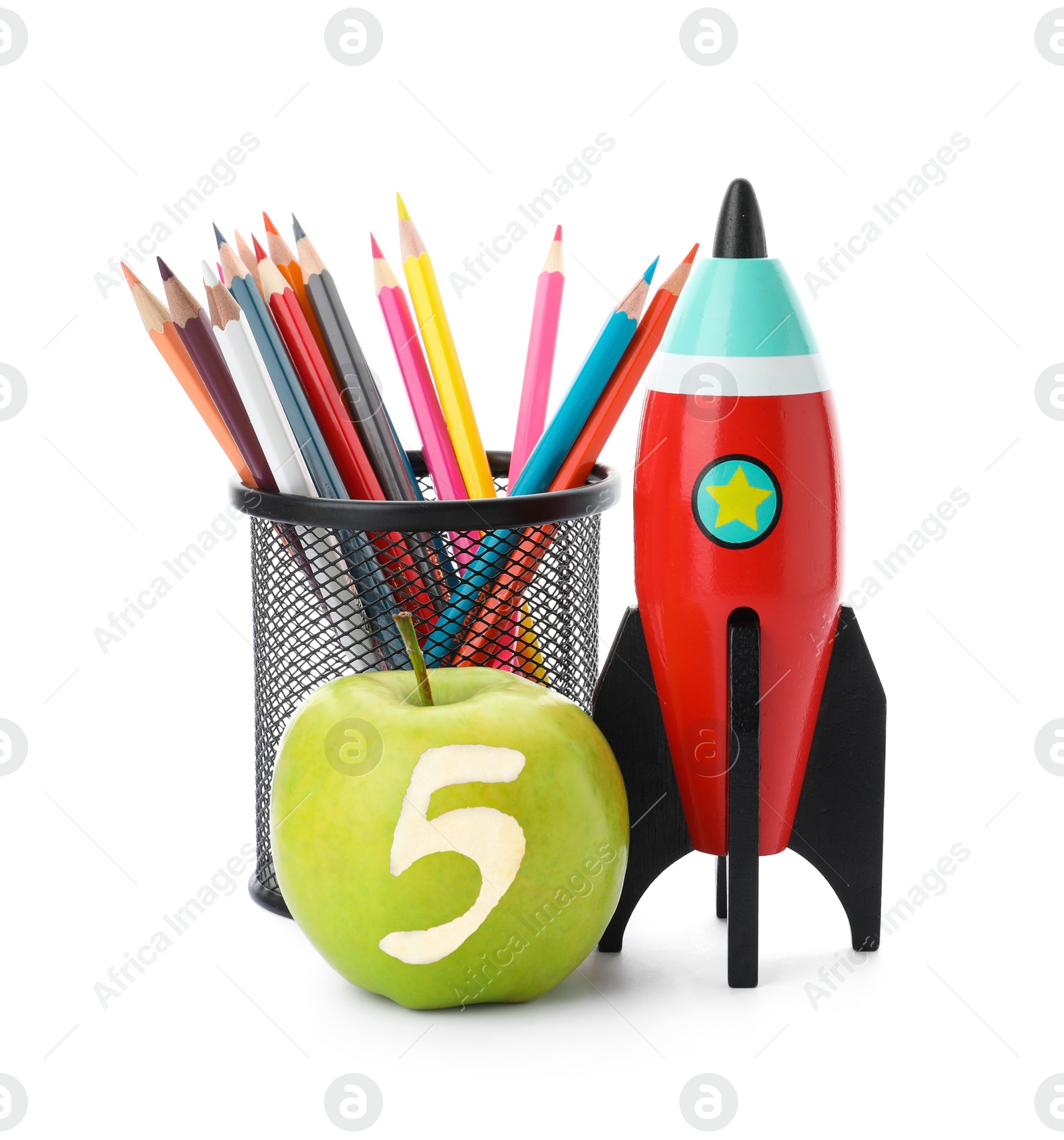 Image of Apple with carved number five as school grade. Bright toy rocket and pencils on white background