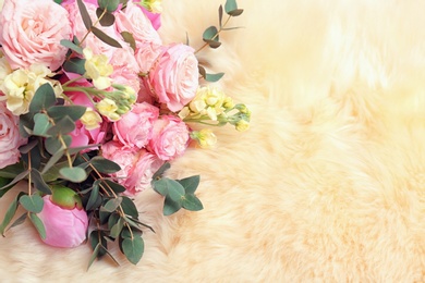 Photo of Bouquet of beautiful fragrant flowers on furry fabric