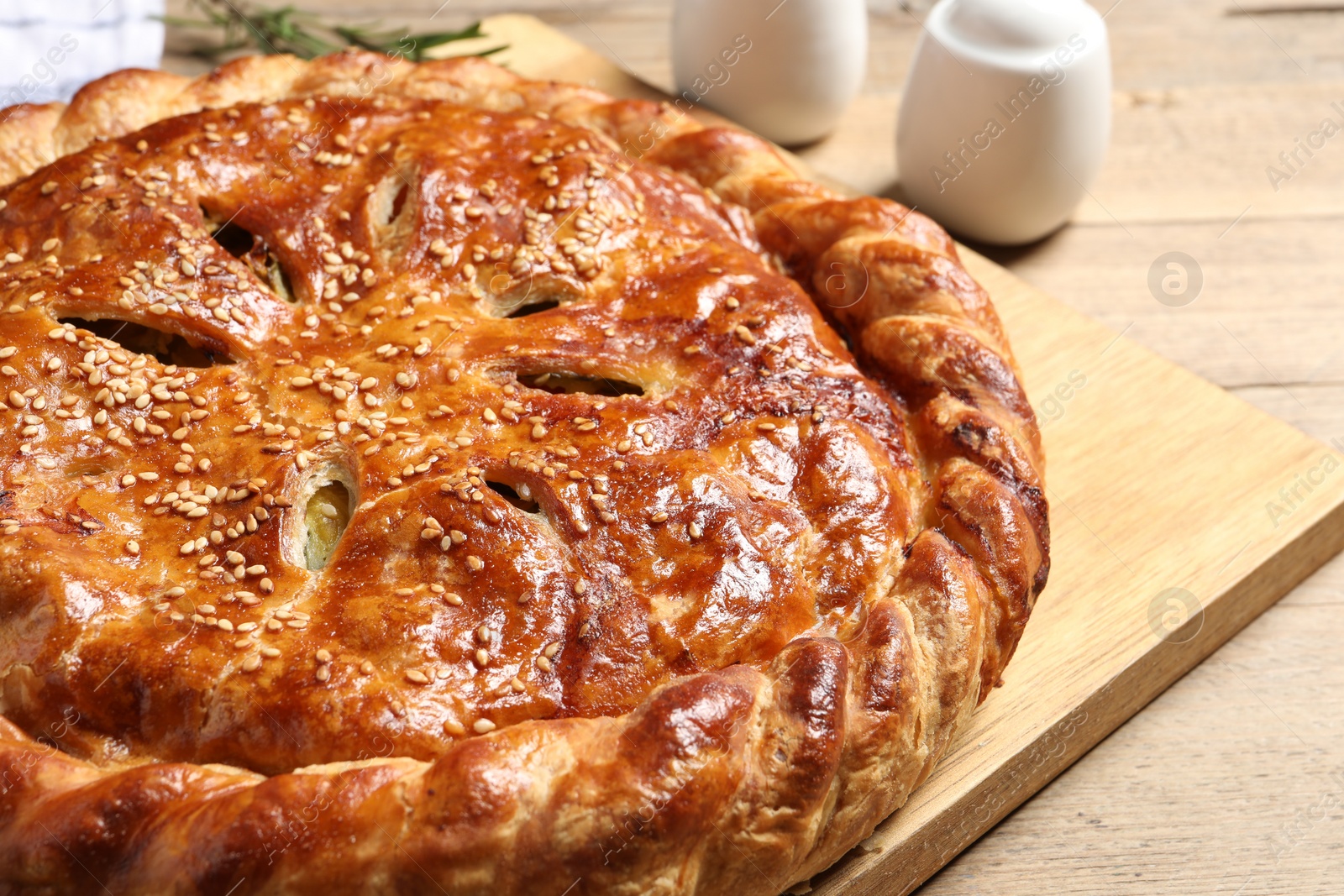 Photo of Tasty homemade pie with filling on wooden table, closeup