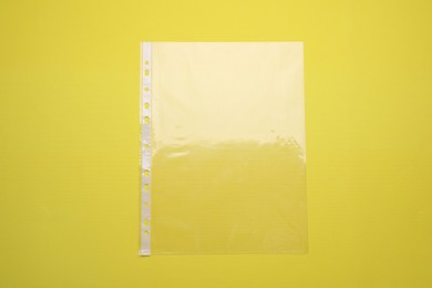 Empty punched pocket on yellow background, top view