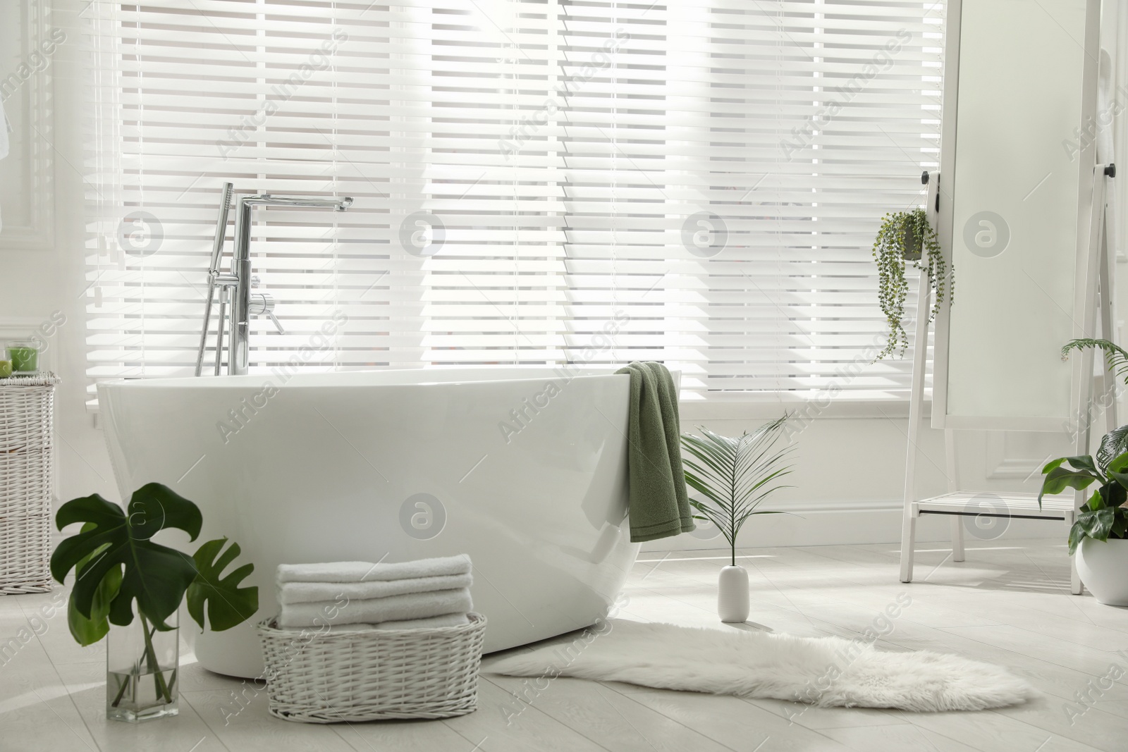 Photo of Stylish bathroom interior with green plants. Home design