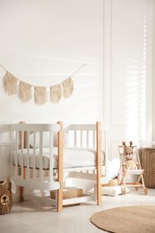 Photo of Baby room interior with stylish furniture and toys