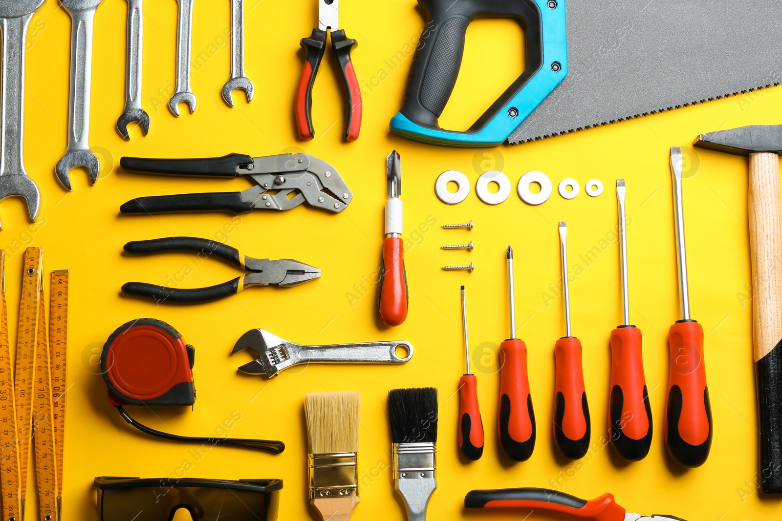 Photo of Flat lay composition with construction tools on color background