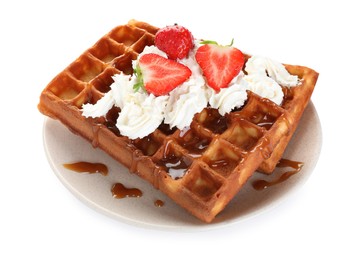 Photo of Delicious Belgian waffles with strawberries, whipped cream and caramel sauce on white background