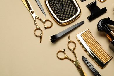 Different hairdresser tools on beige background, flat lay. Space for text