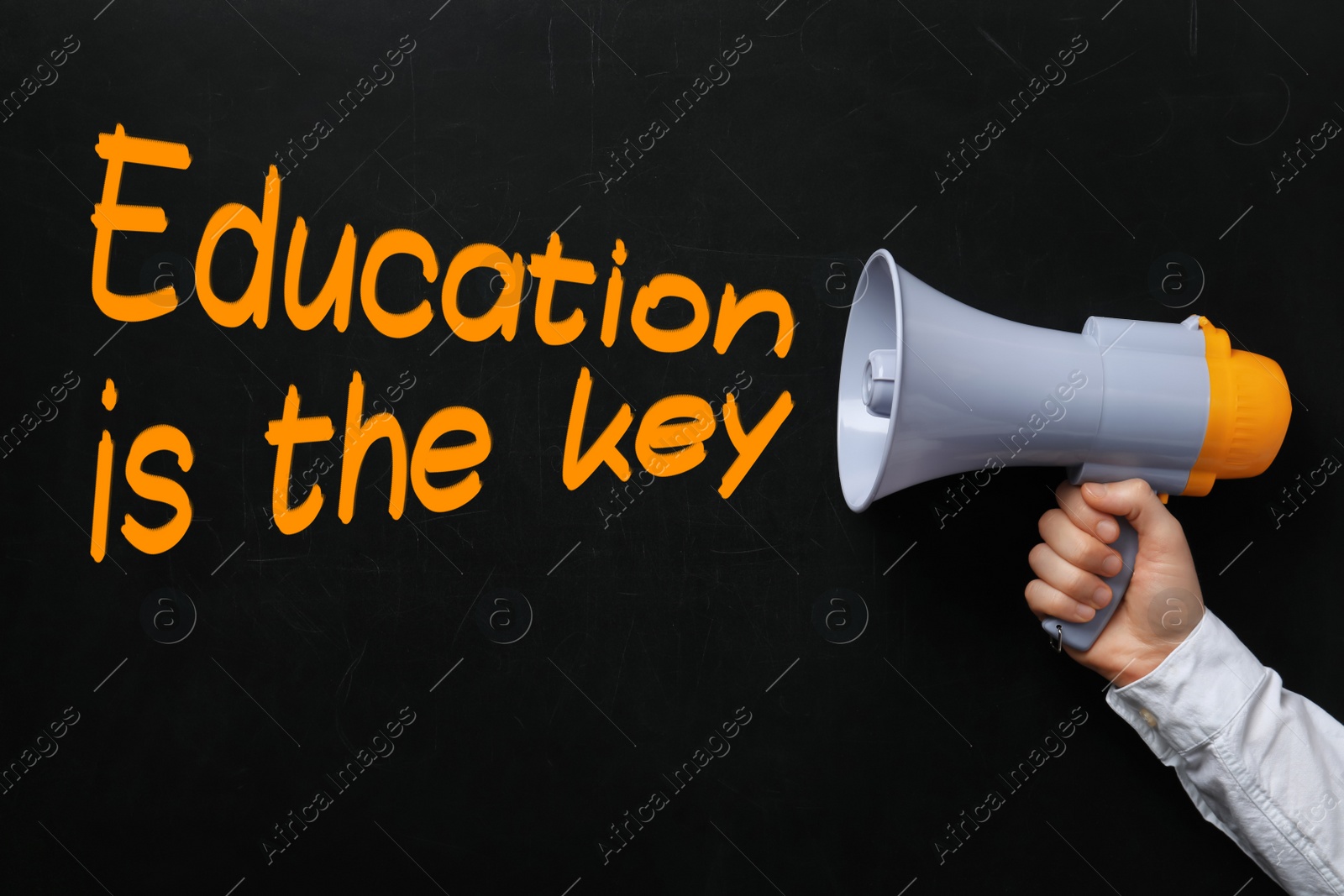 Image of Man holding megaphone near chalkboard with phrase Education is the key, closeup. Adult learning