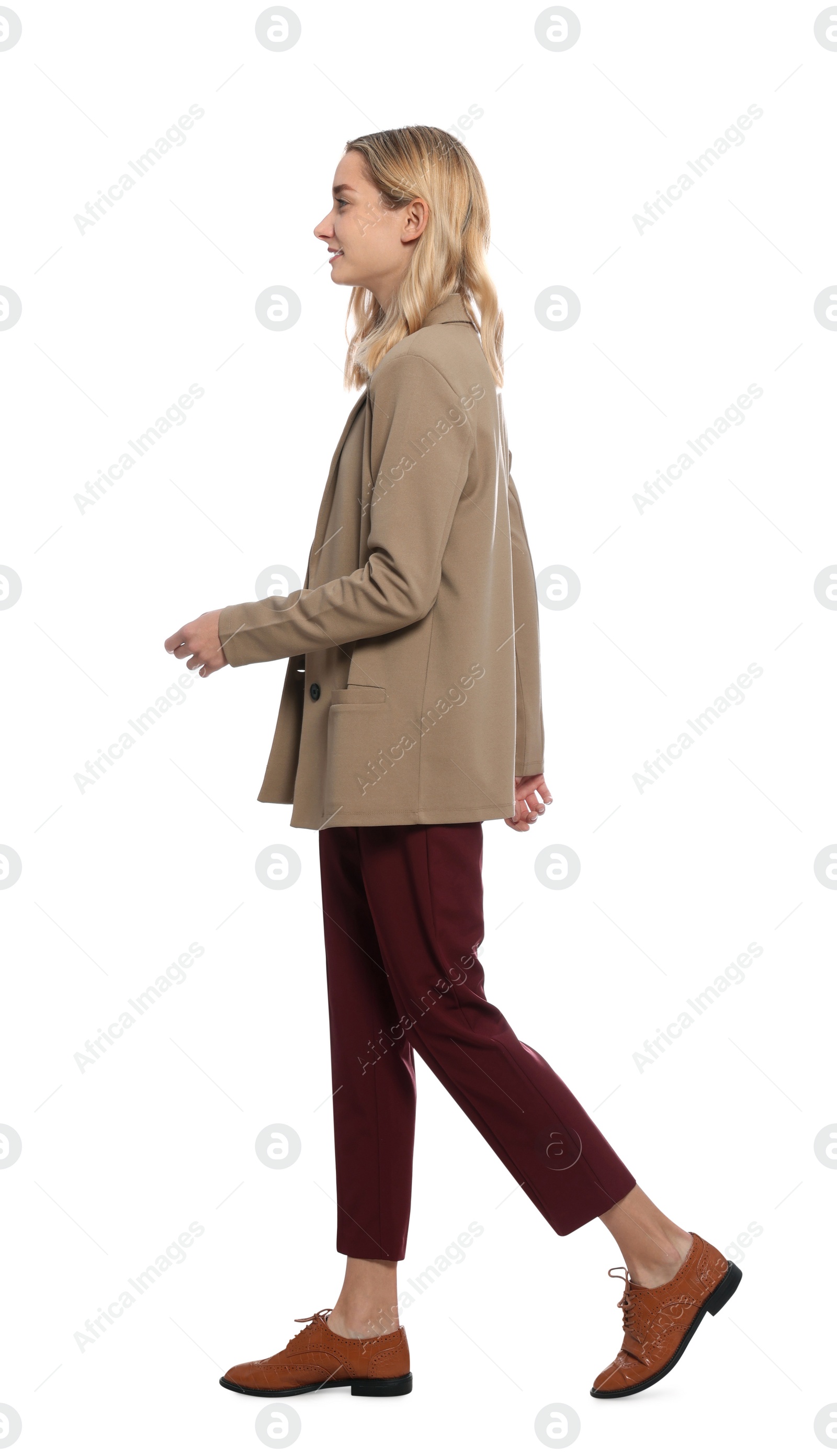 Photo of Beautiful young woman walking on white background