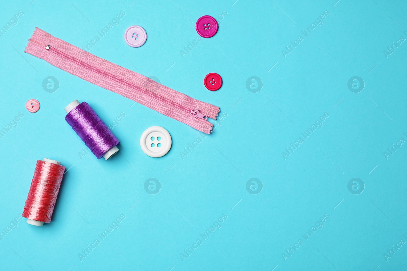 Photo of Flat lay composition with sewing threads on color background