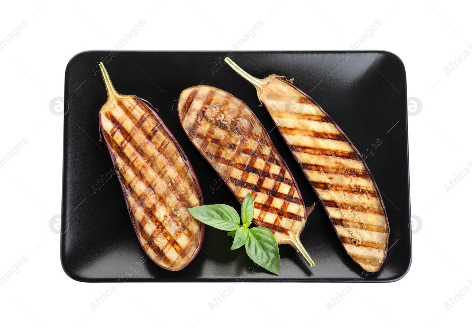 Photo of Delicious grilled eggplant halves with basil isolated on white, top view