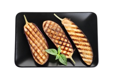 Delicious grilled eggplant halves with basil isolated on white, top view