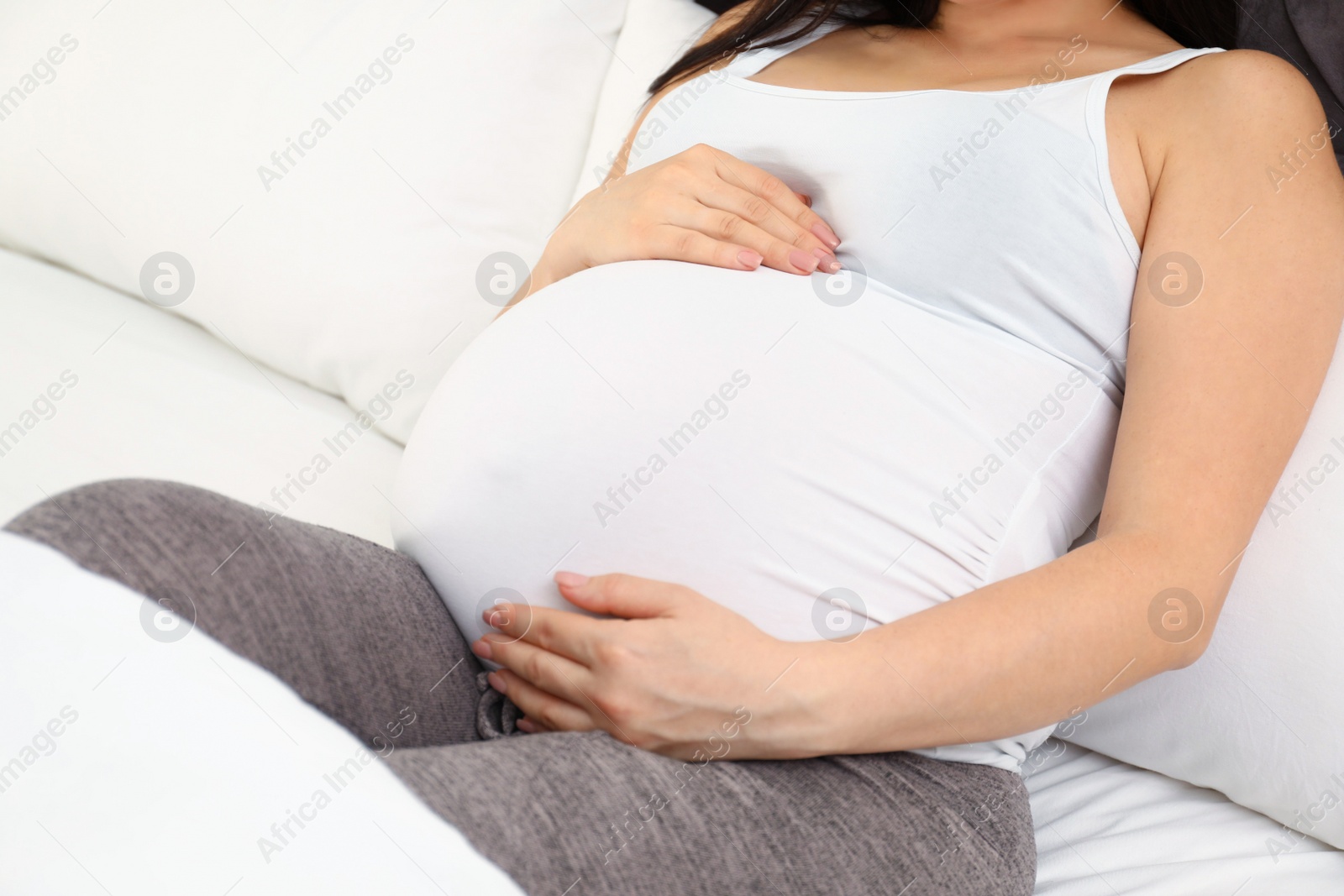 Photo of Pregnant woman in bed at home, closeup