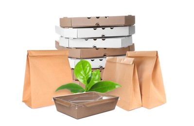 Different containers and green fresh leaves on white background