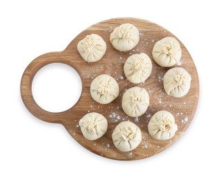 Photo of Board with uncooked khinkali (dumplings) isolated on white, top view. Georgian cuisine