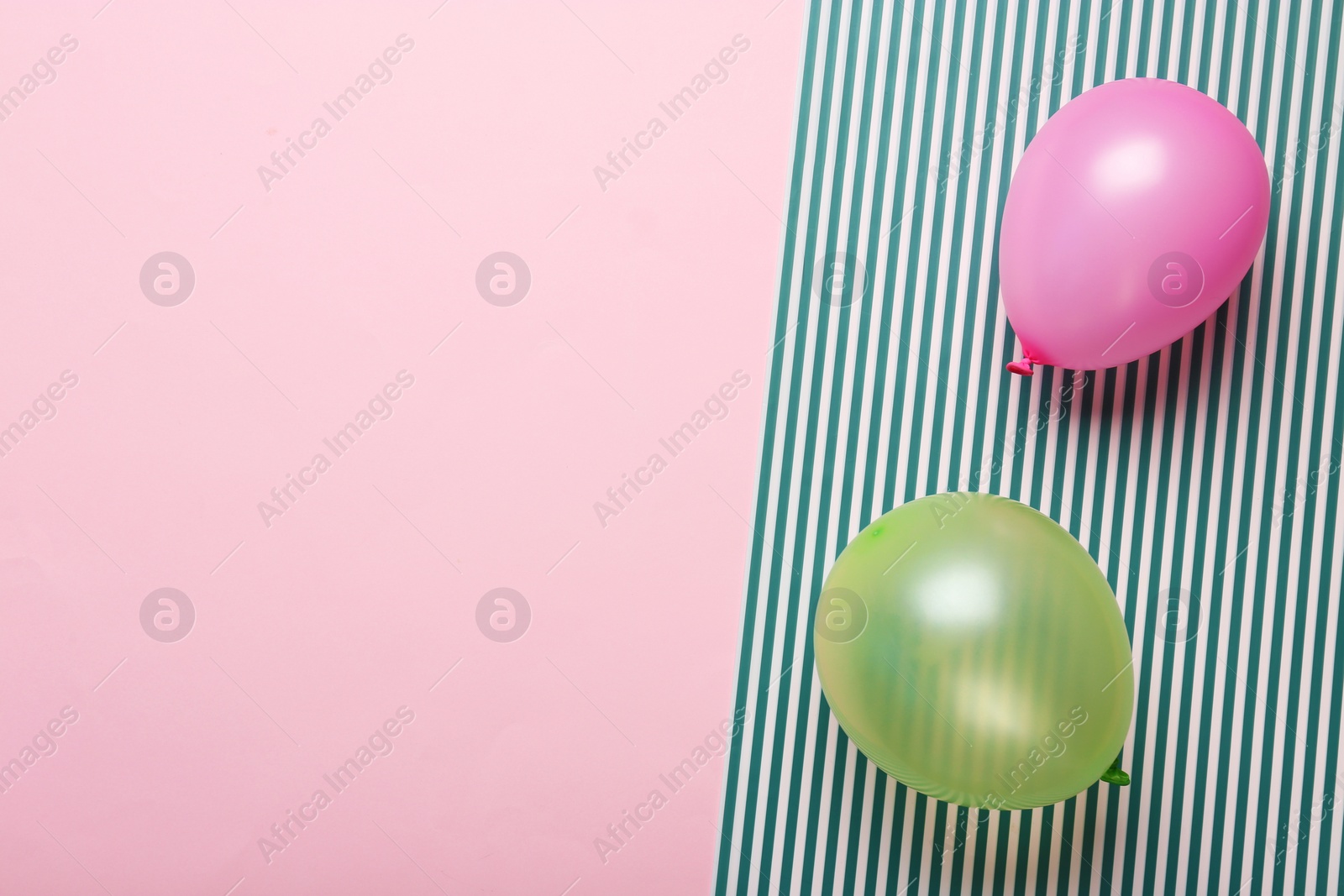 Photo of Flat lay composition with colorful balloons and space for text on color background