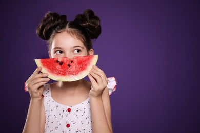 Cute little girl with watermelon on purple background. Space for text