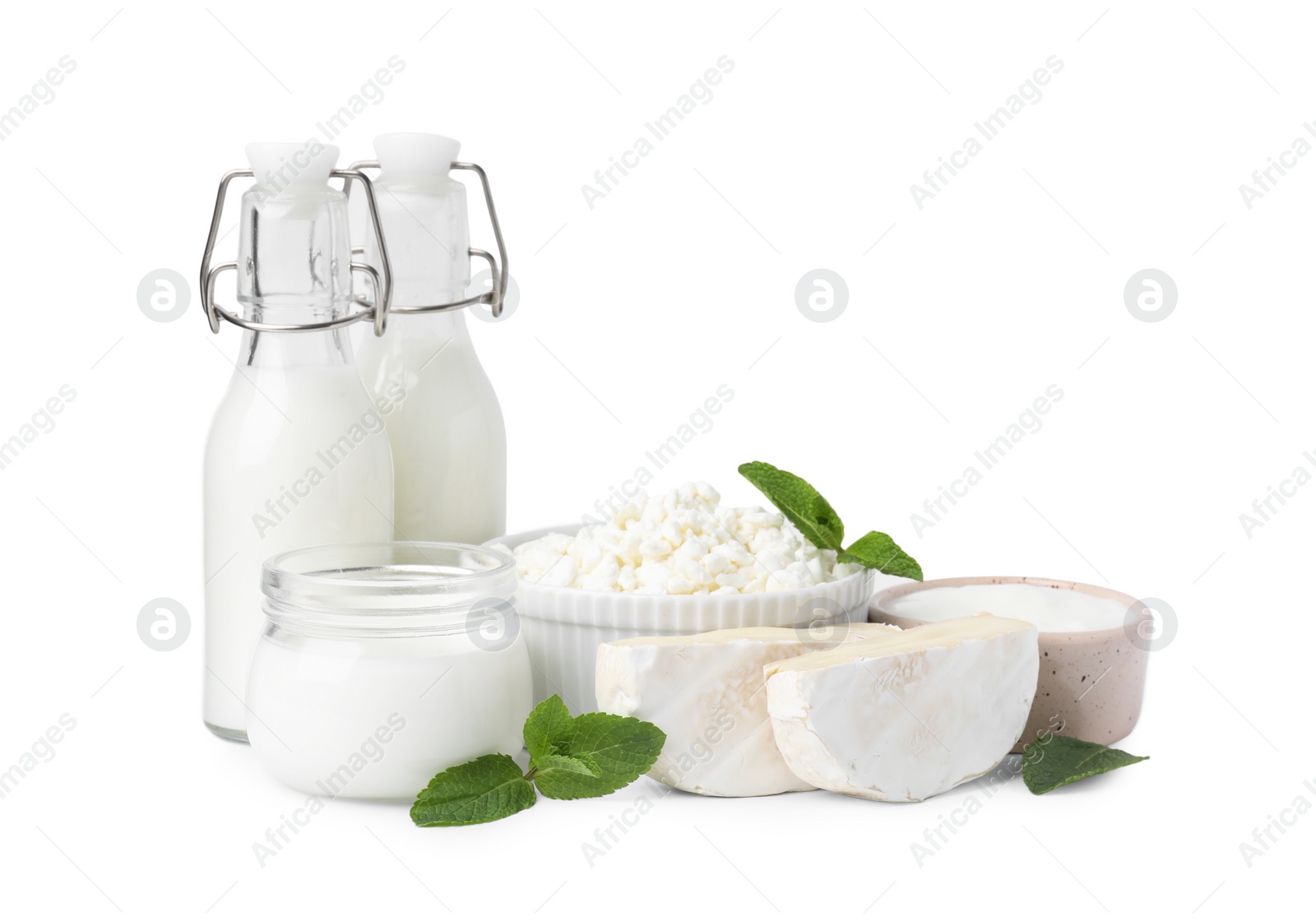 Photo of Different fresh dairy products and mint isolated on white