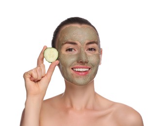 Beautiful woman with clay mask holding piece of cucumber on white background