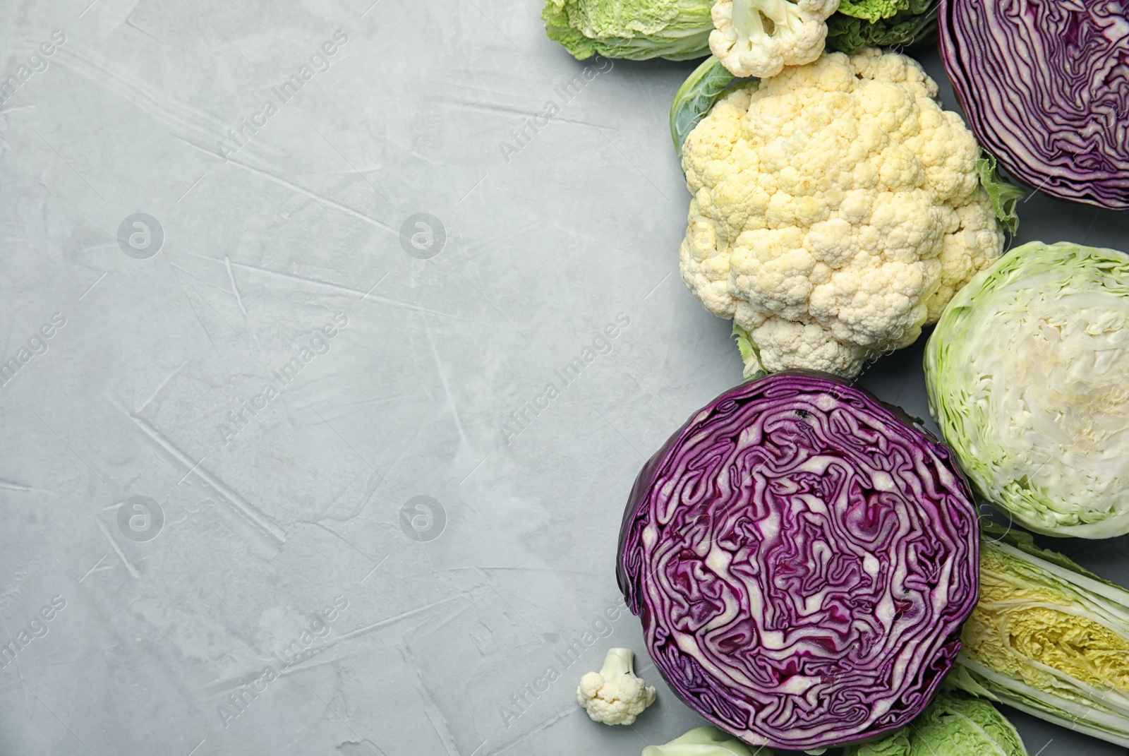 Photo of Flat lay composition with different cabbages on grey background