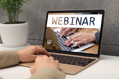 Image of Webinar. Woman using laptop at table, closeup