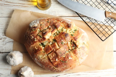 Flat lay composition with homemade garlic bread on table