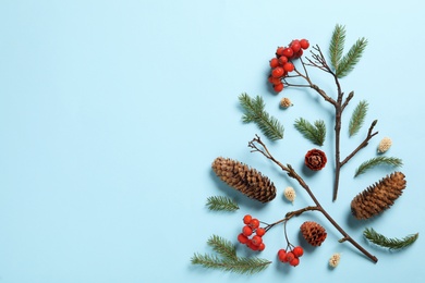 Photo of Flat lay composition with pinecones on light blue background, space for text