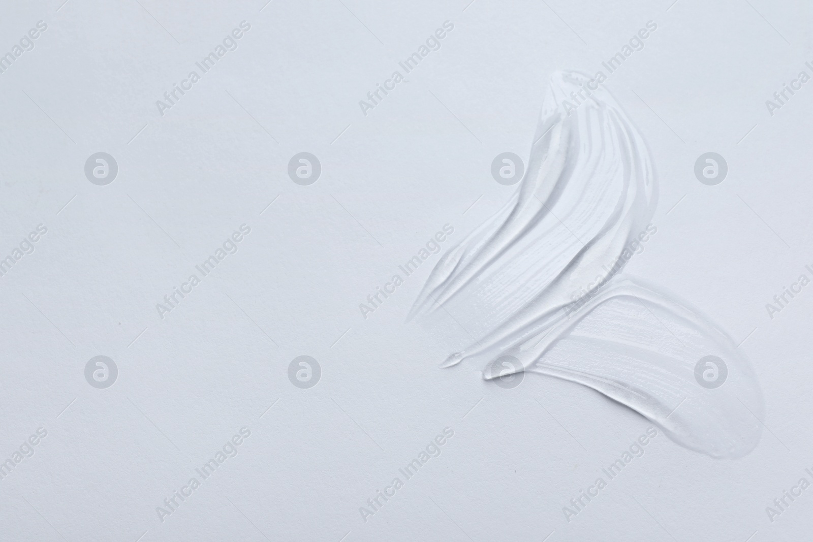 Photo of Swatches of cosmetic gel on white background, top view