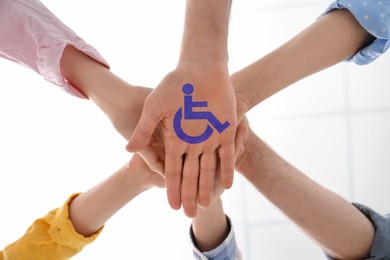 Image of Inclusion concept. People holding hands together, bottom view. International symbol of access
