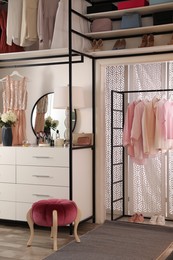Modern wardrobe room interior with stylish furniture