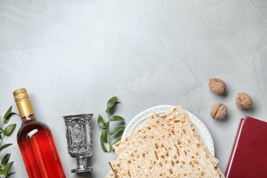 Photo of Flat lay composition with symbolic Passover (Pesach) items on light background, space for text