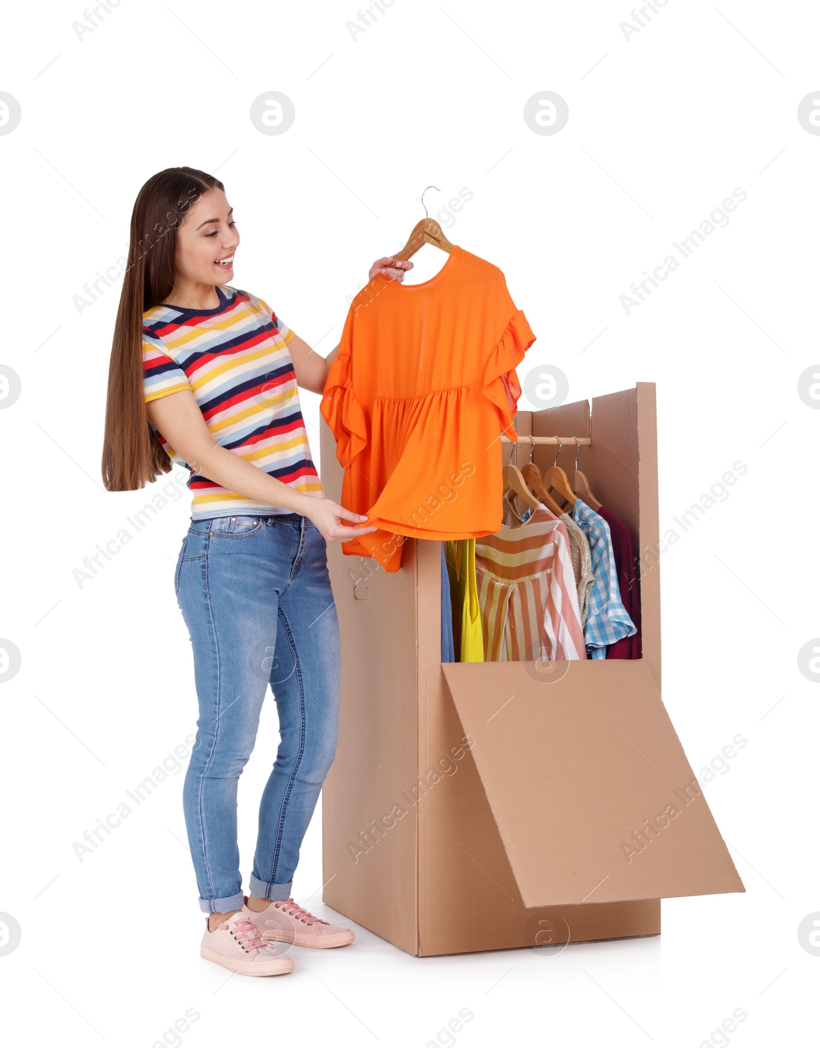 Photo of Young woman near wardrobe box on white background