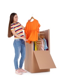 Photo of Young woman near wardrobe box on white background