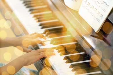 Christmas and New Year music. Little girl playing piano indoors, closeup. Bokeh effect