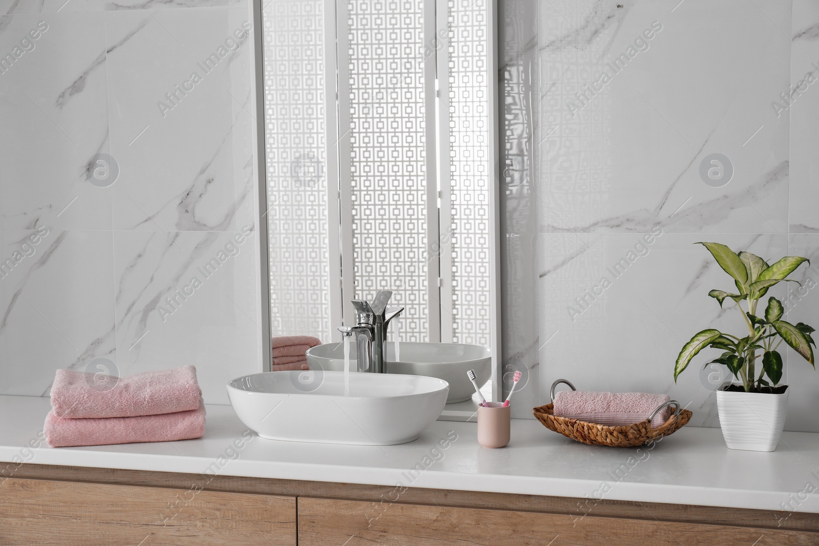 Photo of Modern mirror and vessel sink in stylish bathroom