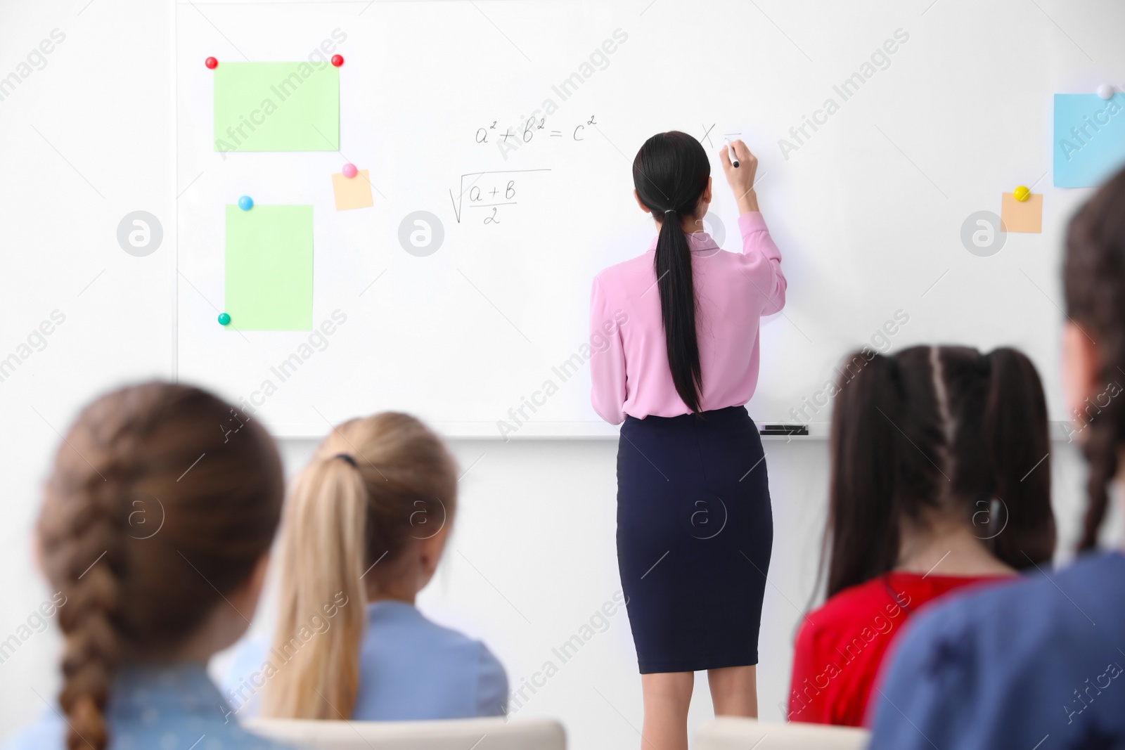 Photo of Young teacher and students in modern classroom