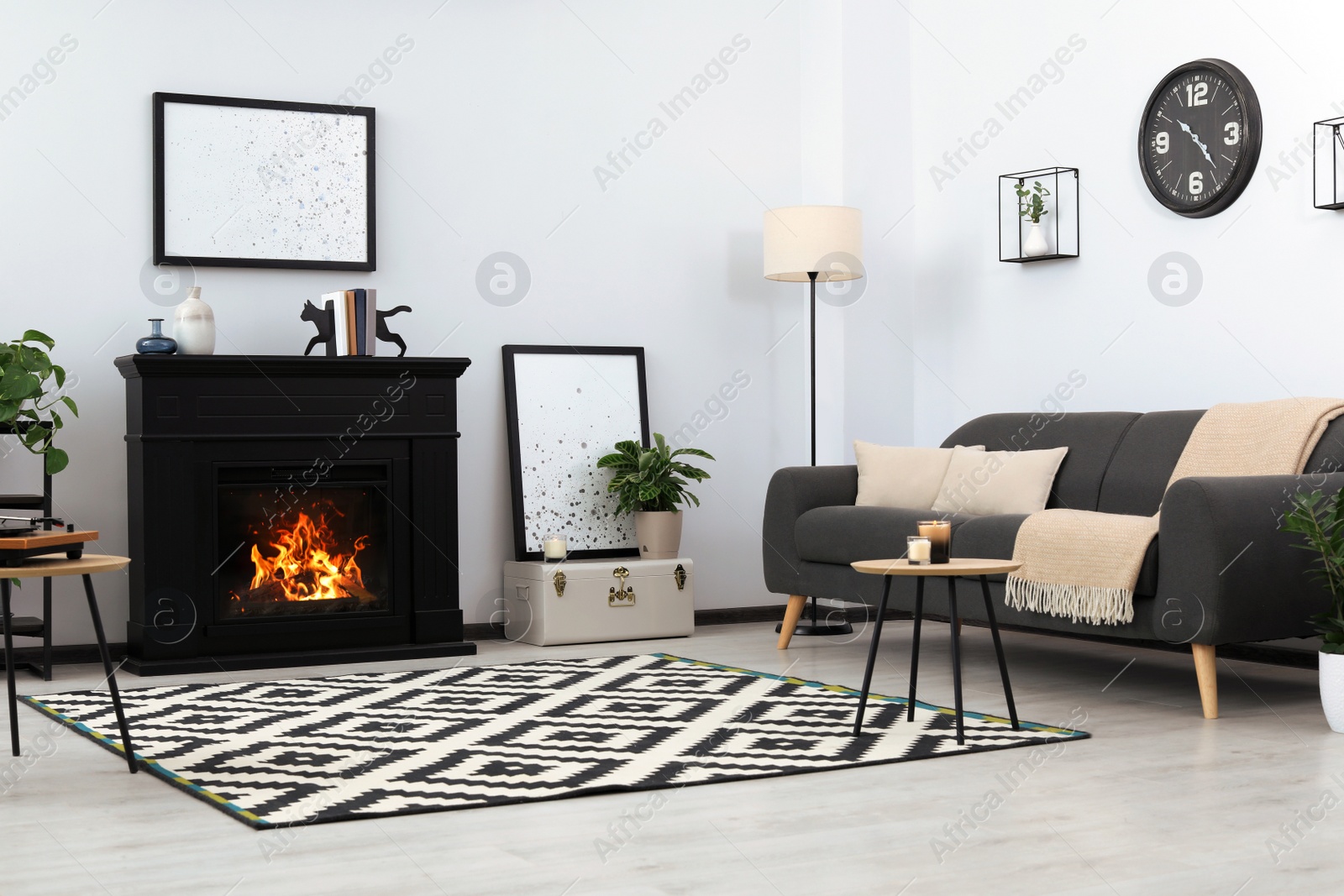 Photo of Stylish living room interior with fireplace and comfortable sofa