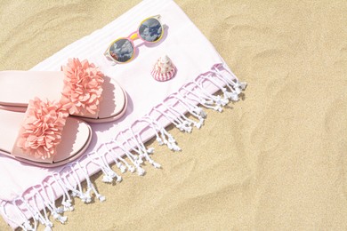 Stylish beach accessories on sand outdoors, above view. Space for text