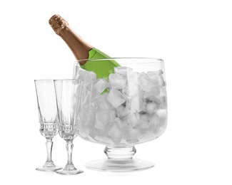 Bottle of champagne in vase with ice and flutes on white background