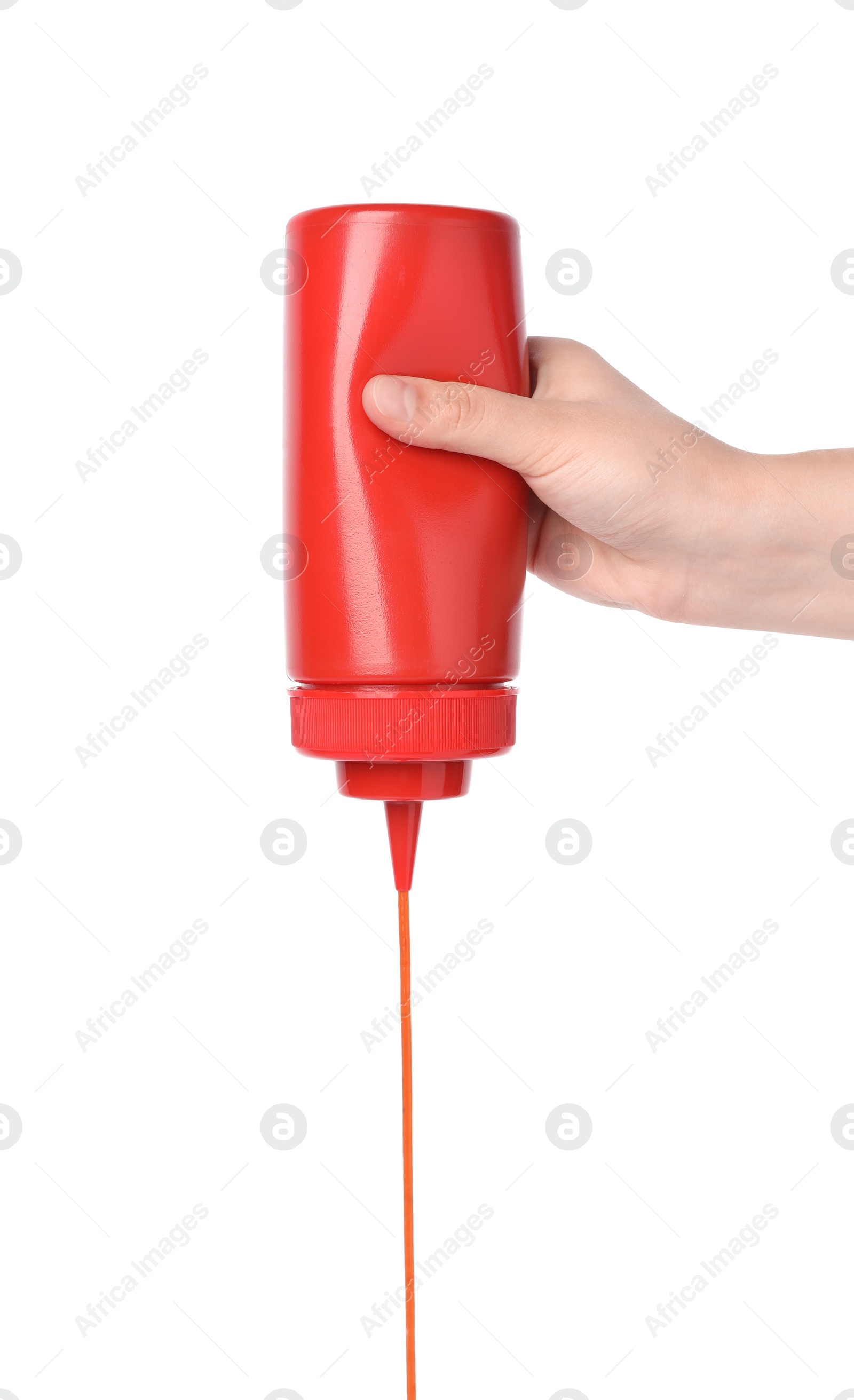 Photo of Woman pouring tasty ketchup from bottle on white background, closeup