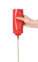 Photo of Woman pouring tasty ketchup from bottle on white background, closeup