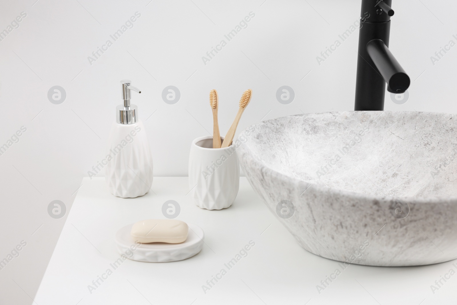 Photo of Different bath accessories and personal care products on white countertop in bathroom