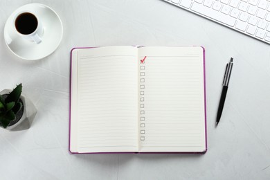 Photo of Notebook with checkboxes, cup of coffee and plant on white table, flat lay. Checklist