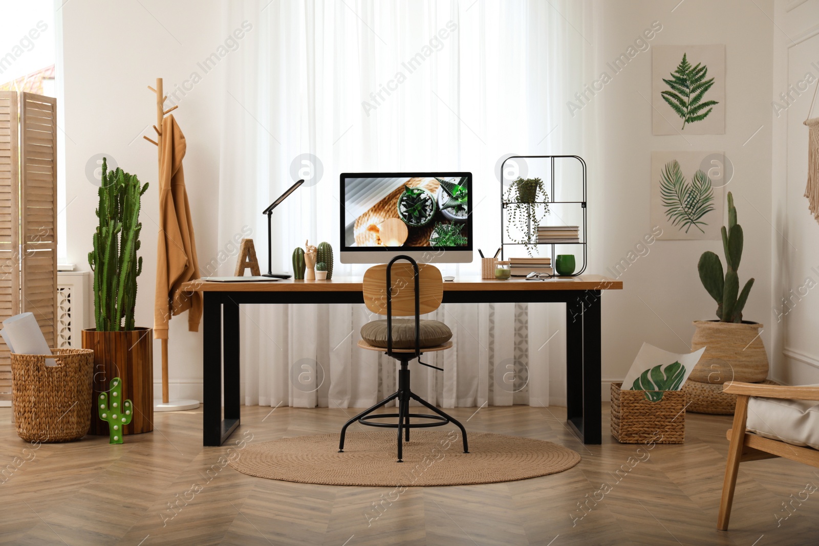 Photo of Modern workplace with computer in room. Interior design