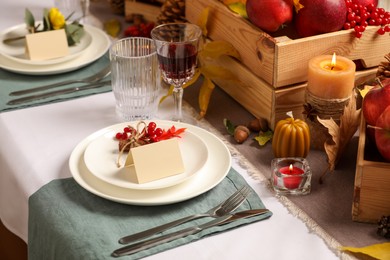 Photo of Beautiful autumn place setting with blank cards and decor on table