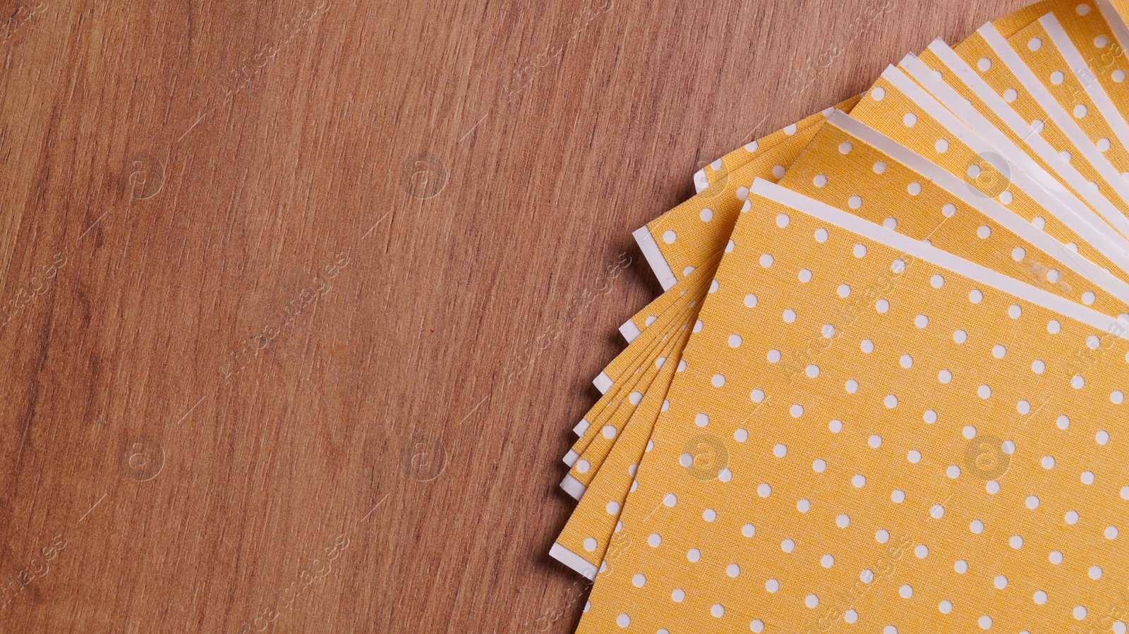 Photo of Pepper plasters on wooden table, flat lay. Space for text