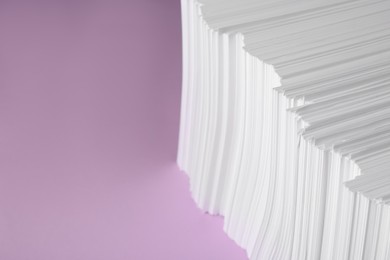 White paper sheets on violet background, space for text