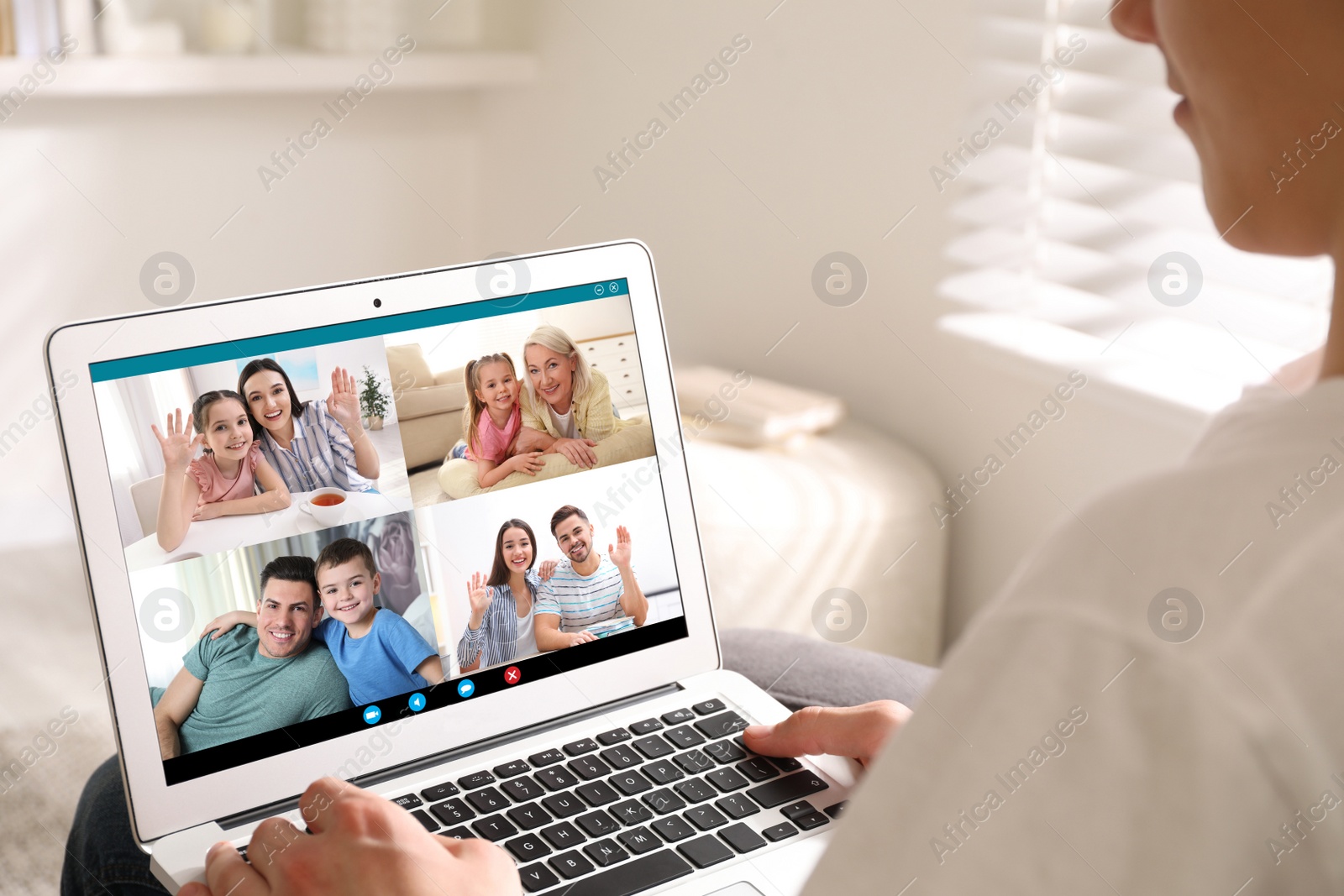 Image of Man having online meeting with family members via videocall application at home, closeup