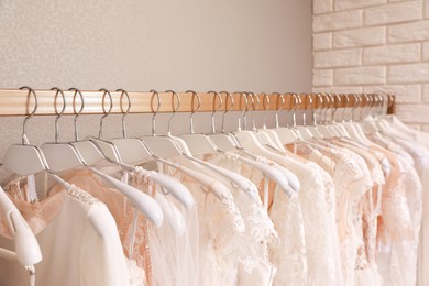 Different wedding dresses on hangers in boutique