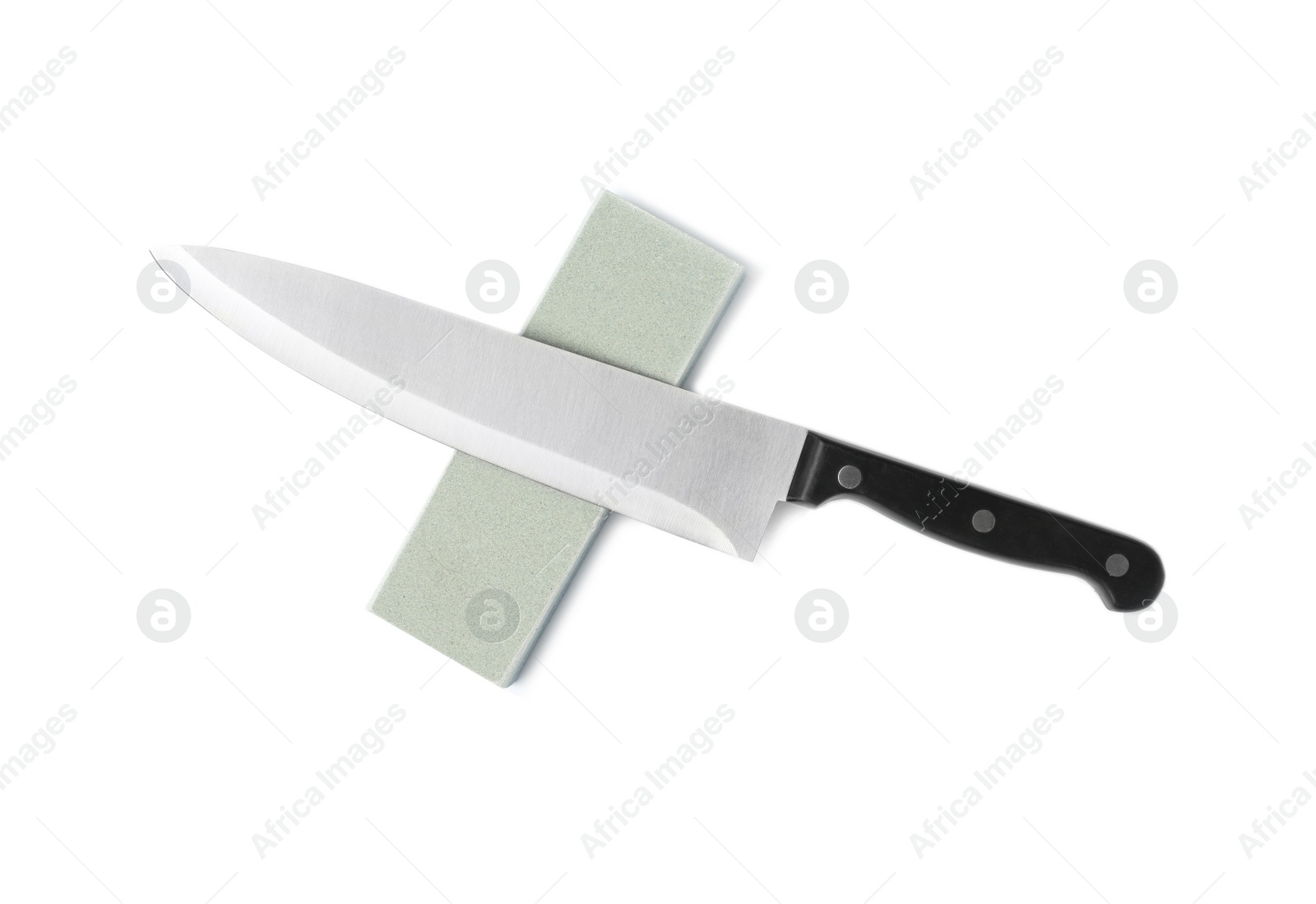 Photo of Chef's knife and grindstone isolated on white, top view