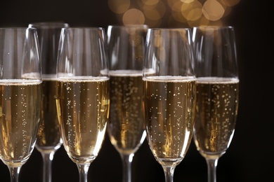 Many glasses of champagne on blurred background, closeup